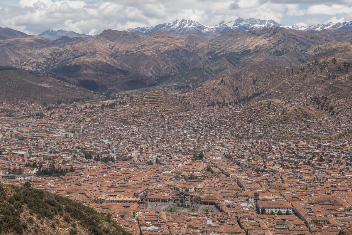 Cusco's rooftops against a mountain backdrop, the destination of the Lima to Cusco flight