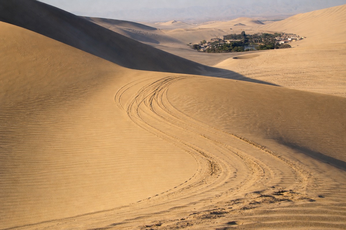 Dune buggy tracks carved into the Huacachina desert dunes