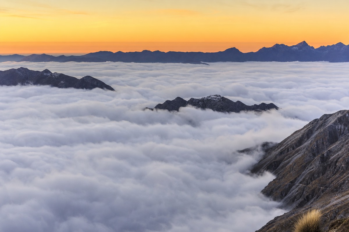 Ridgelines of the Peruvian Andes rising above a cloud inversion when flying from Lima to Cusco